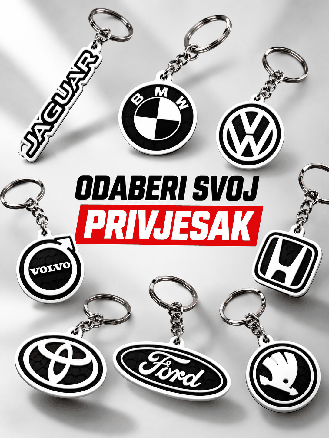 Privjesak za ključeve s metalnim prstenovima i crno-bijelim 3D logotipima automobilskih marki, uključujući BMW, Volkswagen i Ford.
